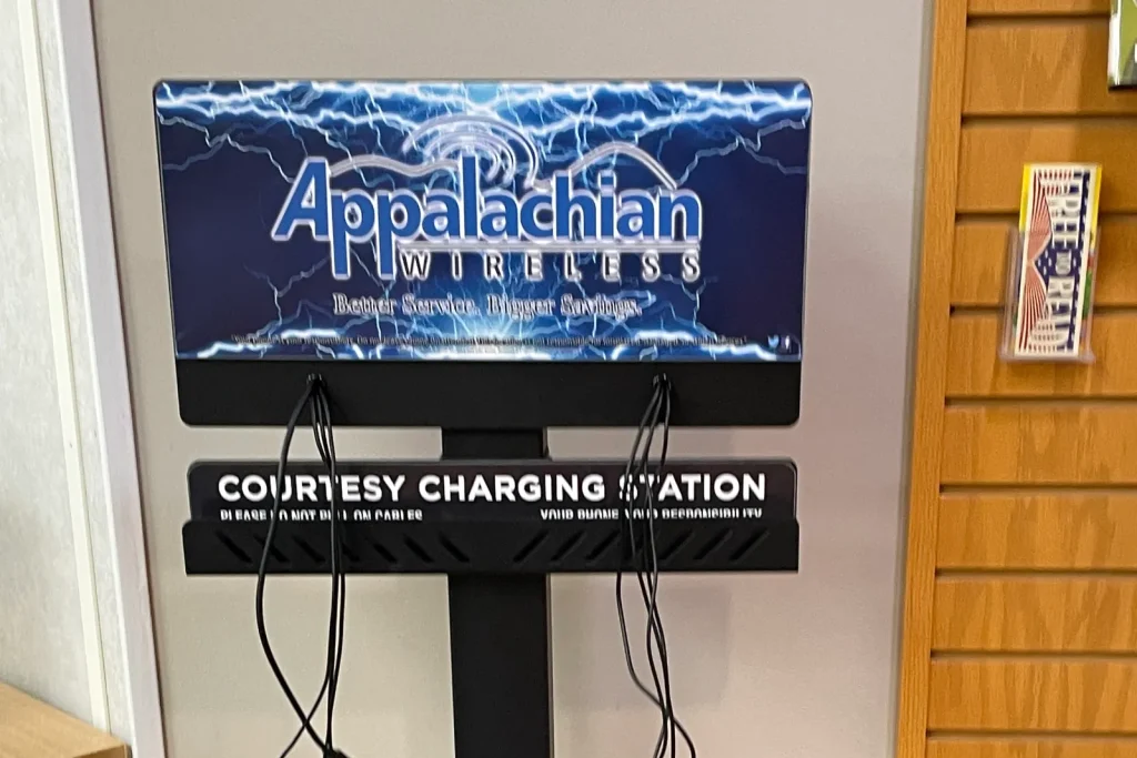 A courtesy phone-charging station with hanging charging cables inside an Eastern Kentucky library.